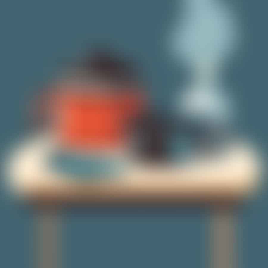 A pair of insulated gloves, goggles, dry ice pellets, a large container, and a kettle of hot water arranged on a table.